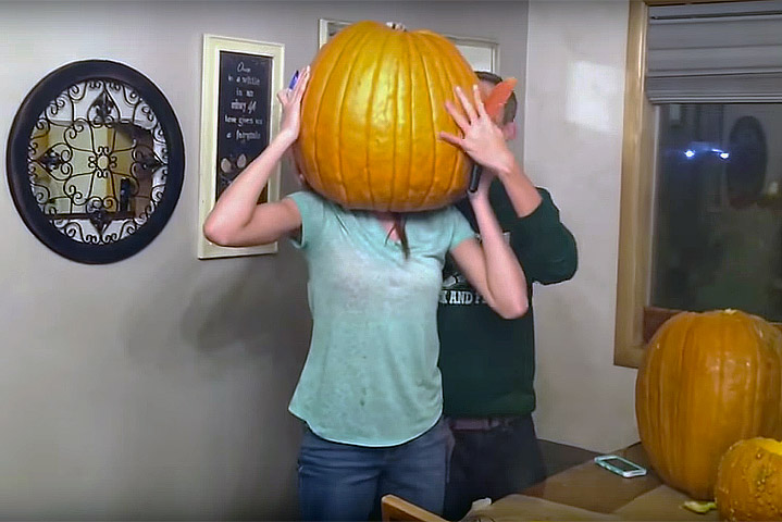 Teen gets her head stuck inside a giant pumpkin!